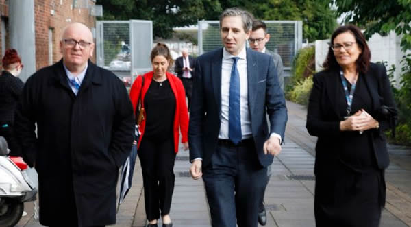 Minister Simon Harris with principal Cecilia Munroe and Vincent Jackson